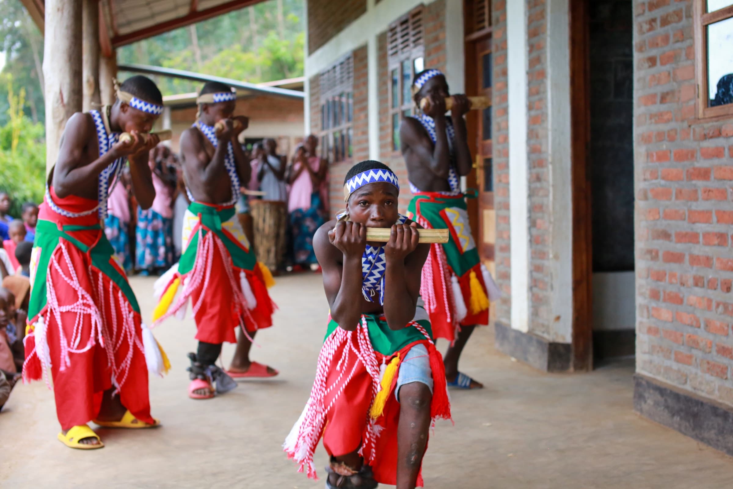 Young performers sharing a traditional dance outside the Sunzu Village library
